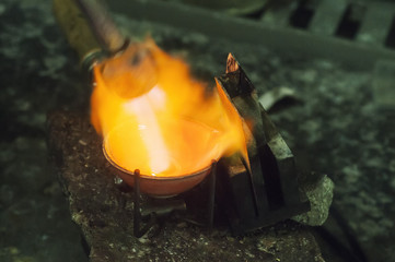 Craft jewelery making with professional tools. Macro shot. A handmade jeweler process, manufacture of jewellery. Melting metal