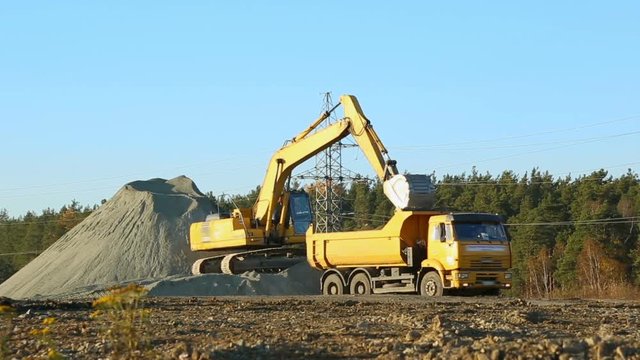 Excavator loading the lorry-track