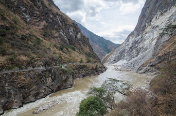 Fototapeta na wymiar The torrential flow through the hills in Tibet