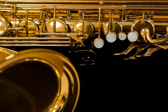  Fragment of saxophone on a black background