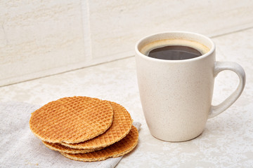 Cup of coffee and waffles isolated on the white background, close-up