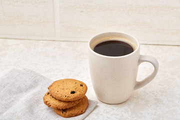 Cup of coffee and biscuit isolated on the white background, close-up, top view