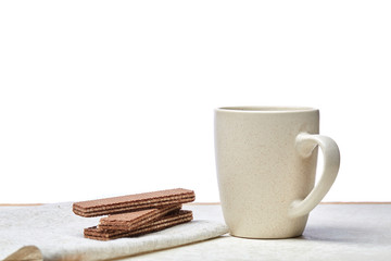 Cup of coffee and waffles isolated on the white background, close-up.