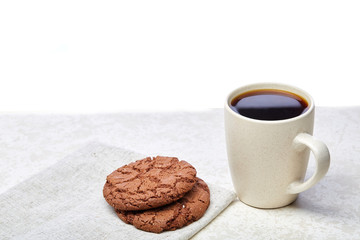 Cup of coffee and biscuit isolated on the white background, close-up.
