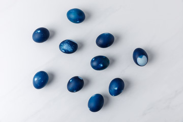 top view of blue painted easter eggs on marble table