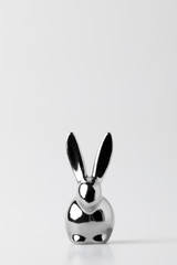 Silver statuette of easter bunny on white