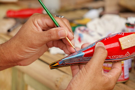 man making paint model Kolek ship