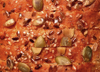 Cereal bread texture, a top view closeup photo image of a sliced cereal bread loaf present a detail...