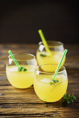Glasses of orange cocktails with ice and mint