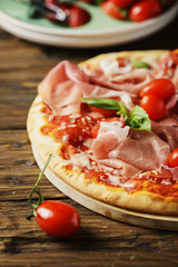 Italian pizza with mozzarella, tomato and bacon