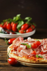 Italian pizza with mozzarella, tomato and bacon