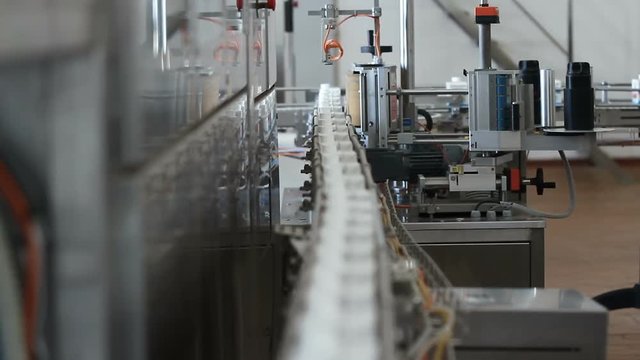 Milk in cardboard packages on a conveyor belt. Dairy products in packagingaging are moving along the conveyor at a dairy factory.
