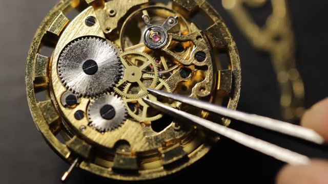Watchmaker is repairing the mechanical watches in his workshop
