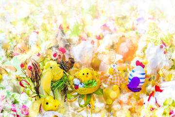 Blurred Easter background with bokeh effect. Chickens, eggs, bunnies and other Easter decorations.