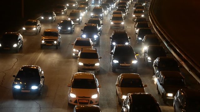 Car traffic jam on the highway. Evening, night, headlight 