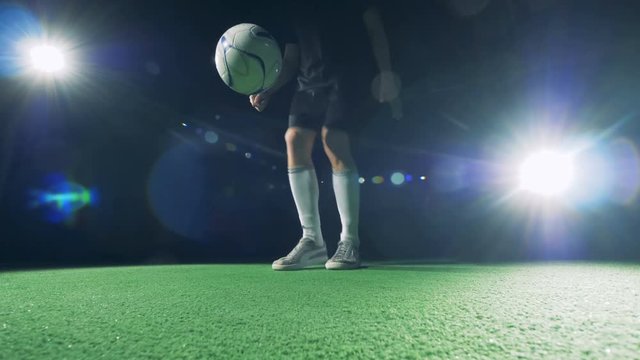 Soccer player is making double around the world trick with his right foot.