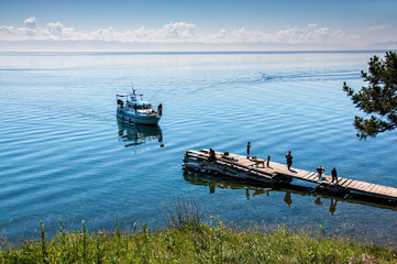 Fototapeta premium Bolshiye Koti, RUSSIA - JULY 18: macrophototour, members of team are waiting boat and taking pictures near lake Baikal, July 18, 2010 in Bolshiye Koti, Irkutskiy region, Russia.