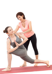 Fototapeta na wymiar woman doing yoga under the guidance of a trainer
