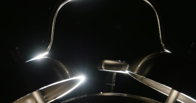 Twin Bell Alarm Clock Ringing Isolated on Black