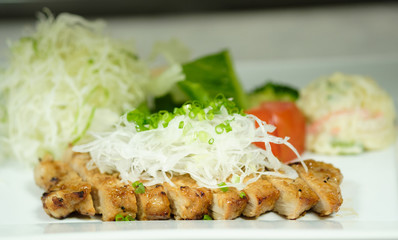 Grilled pork chop in dish and vegetable