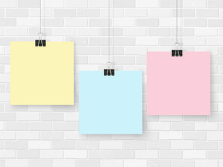 Posters on binder clips. Paper templates on brick wall. Realistic mock up. Empty notepad sheet for your business design. Brick wall. Vector templates for lettering, quote, images or logos.