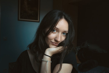 girl smiling shyly with her hand in his face
