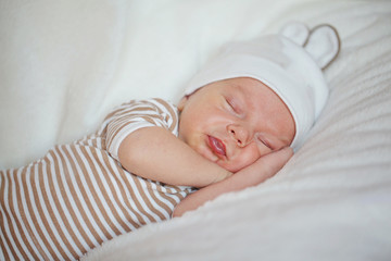 Cute little baby newborn sleeping at home