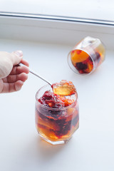 fruit jelly in serving glasses, pieces of jelly on the spoon, life style