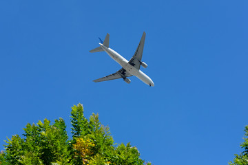 Plane flying over with blue sky above