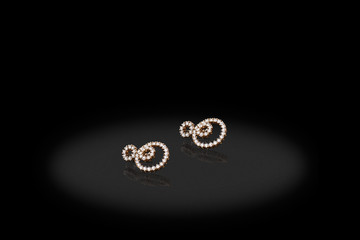 Yellow gold precious earrings with big diamonds on black background.