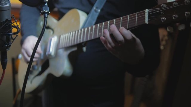 4k Guitarist plays great music by vintage electric guitar at recording studio