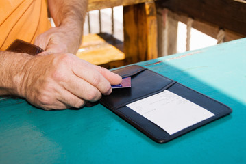Fototapeta na wymiar Man Paying Restaurant Bill with Credit Card