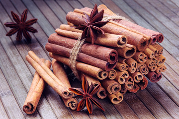 star anise and cinnamon sticks in a bunch on a wooden background