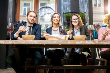 Business people sitting at the table during the dinner in the modern restaurant