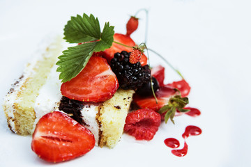 cake with strawberries and forest berries