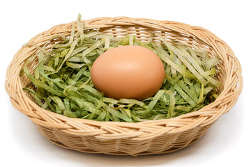 Egg in the wicker basket on white background for healthy food concept
