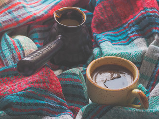 Traditional black coffee and a Turk on the colored textile napkins
