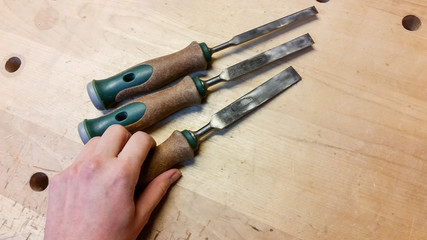 Weibliche Hand arbeitet mit Holz Beitel Werkzeug in Werkstatt