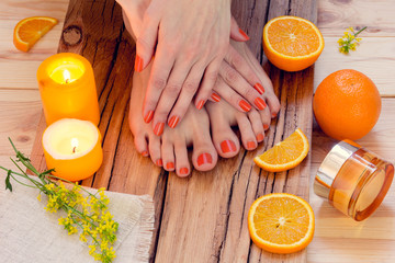 orange manicure around oranges and candles