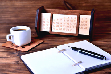 Notebook coffee cup and calendar