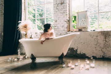 A beautiful boudoir morning of the bride, a pretty girl in a white man's shirt and underwear at a...