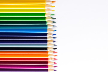 Several colored pencils on a white background with copy space