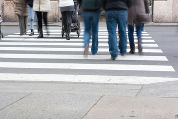 Horizontal View of People Walking and Crossing the Street.