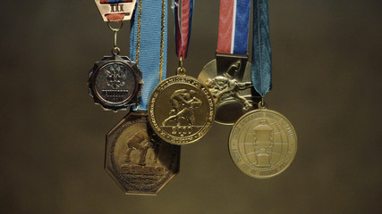 Many gold medals with tricolor ribbons close-up. Medal for first place in the competition in judo. Many medals for a victory
