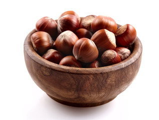 Group of  hazelnuts in a bowl on a white background
