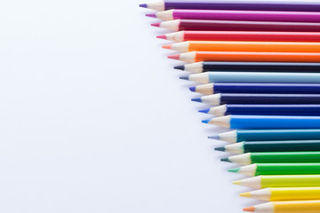 Several colored pencils on a white background with copy space