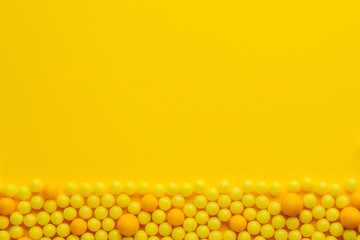 Yellow round pills  on yellow  background. Medicine and pharmacy concept.