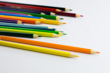 Fototapeta premium Several colored pencils on a white background with copy space