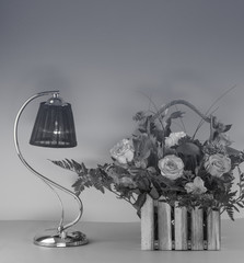 elegant table lamp and bouquet of flowers on the table