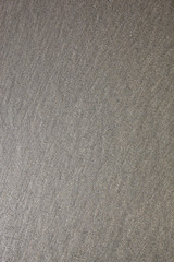 Wet sand with natural patterns on the beach, natural texture